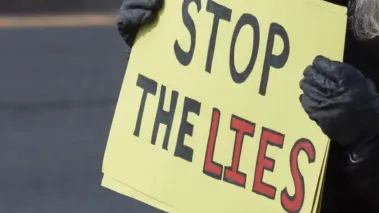 Jan. 11, 2026 – Protester holding a sign at the Ice Out for Good protest in Rockville, MD